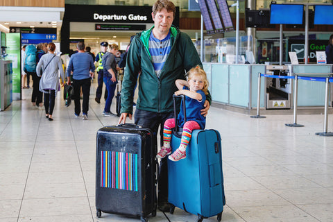 man at airport with toddler with big bags