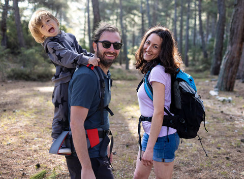 Dad carrying kid with toddler carrier