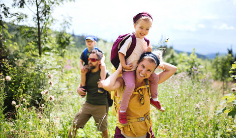 Hiking Family kids on shoulders