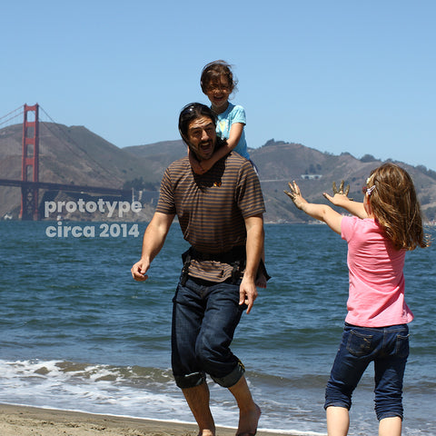 Step Caddy prototype child carrier with the inventor and his kids having fun in front of the Golden Gate Bridge.