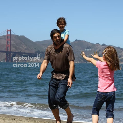 Step Caddy prototype child carrier with the inventor and his kids having fun in front of the Golden Gate Bridge.