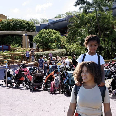 Mum carrying kid with toddler carrier